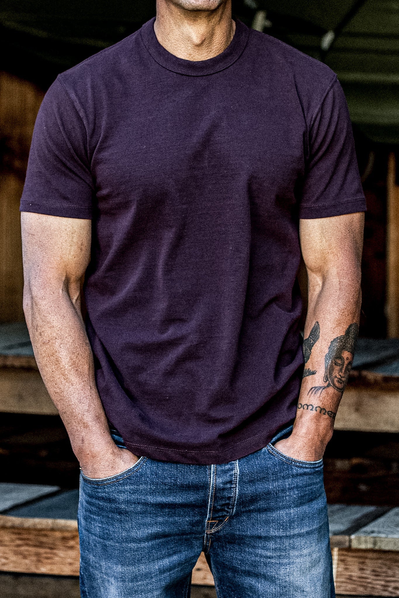 Oxblood heavyweight cotton Bolinas tee worn with blue jeans, hands in pockets.