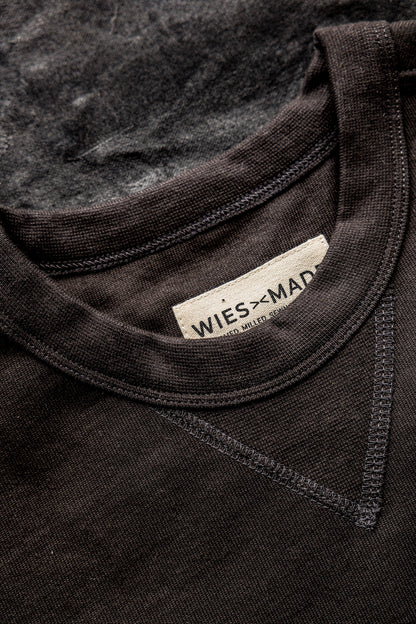 Close-up of basalt rugby jersey pullover's ribbed crew neckline, double-stitched seams, and WiesMade label.