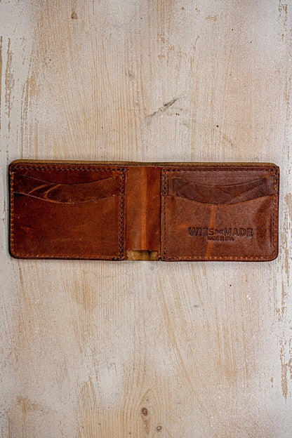 Open tan Horween leather bi-fold wallet showing card slots and WiesMade Made in USA stamp.