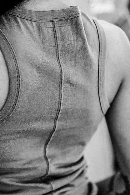 Back view close-up of the Reyes cotton tank showing center seam, neckline binding, and interior label patch.