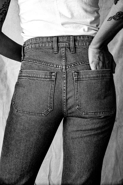 Women’s premium jeans shown from the back, featuring a high waist fit, structured seams, and large back pockets for a sleek, tailored silhouette