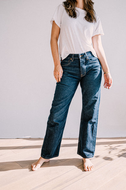 Person wearing Jackie ocean wash mid-rise wide-leg jeans with a white tee, on-model.