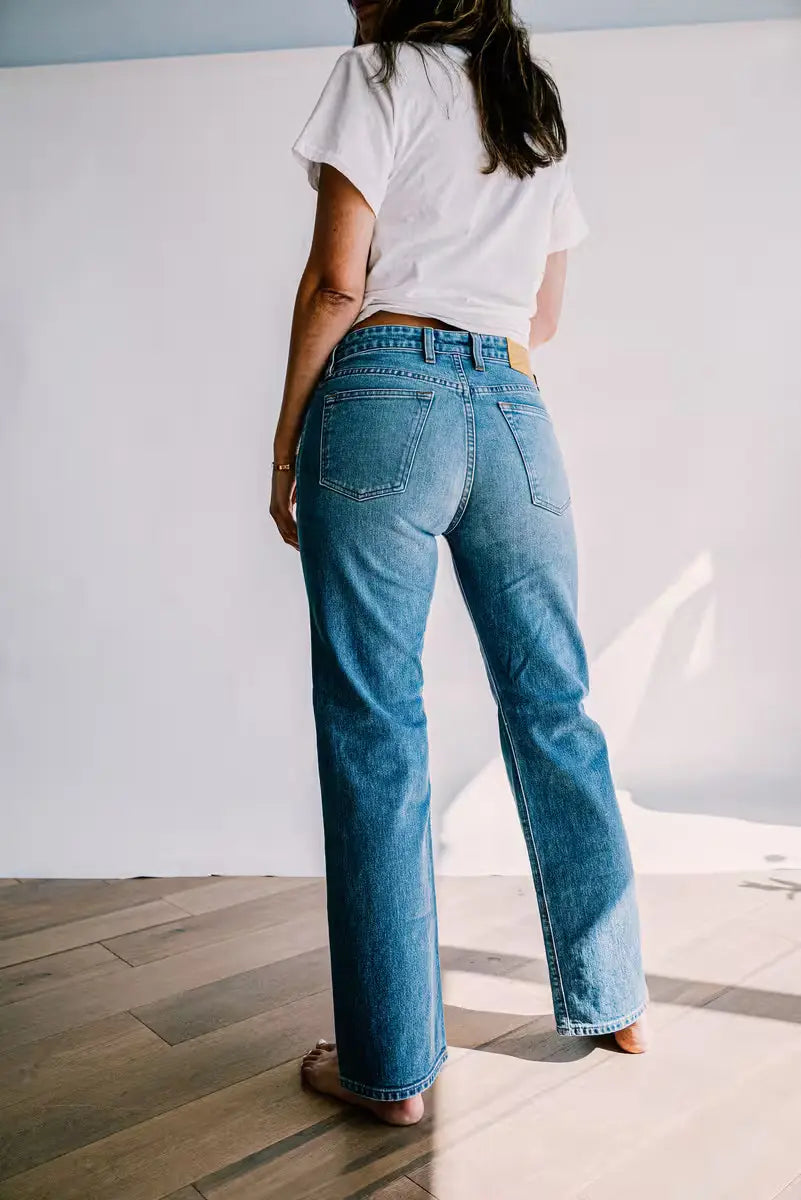 Luxury jeans for women shown from the back, featuring a flattering high rise fit, classic straight leg cut, and medium blue wash with clean stitched detailing