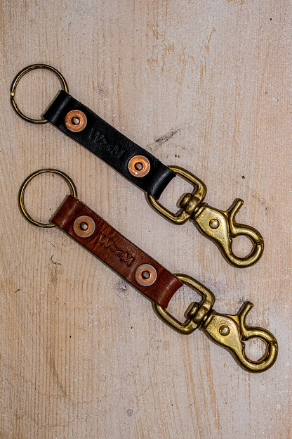 Black and brown Horween leather key clips with brass swivel snaps and copper rivets.
