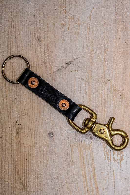 Black Horween leather key clip with brass swivel clasp, copper rivets, and split ring.