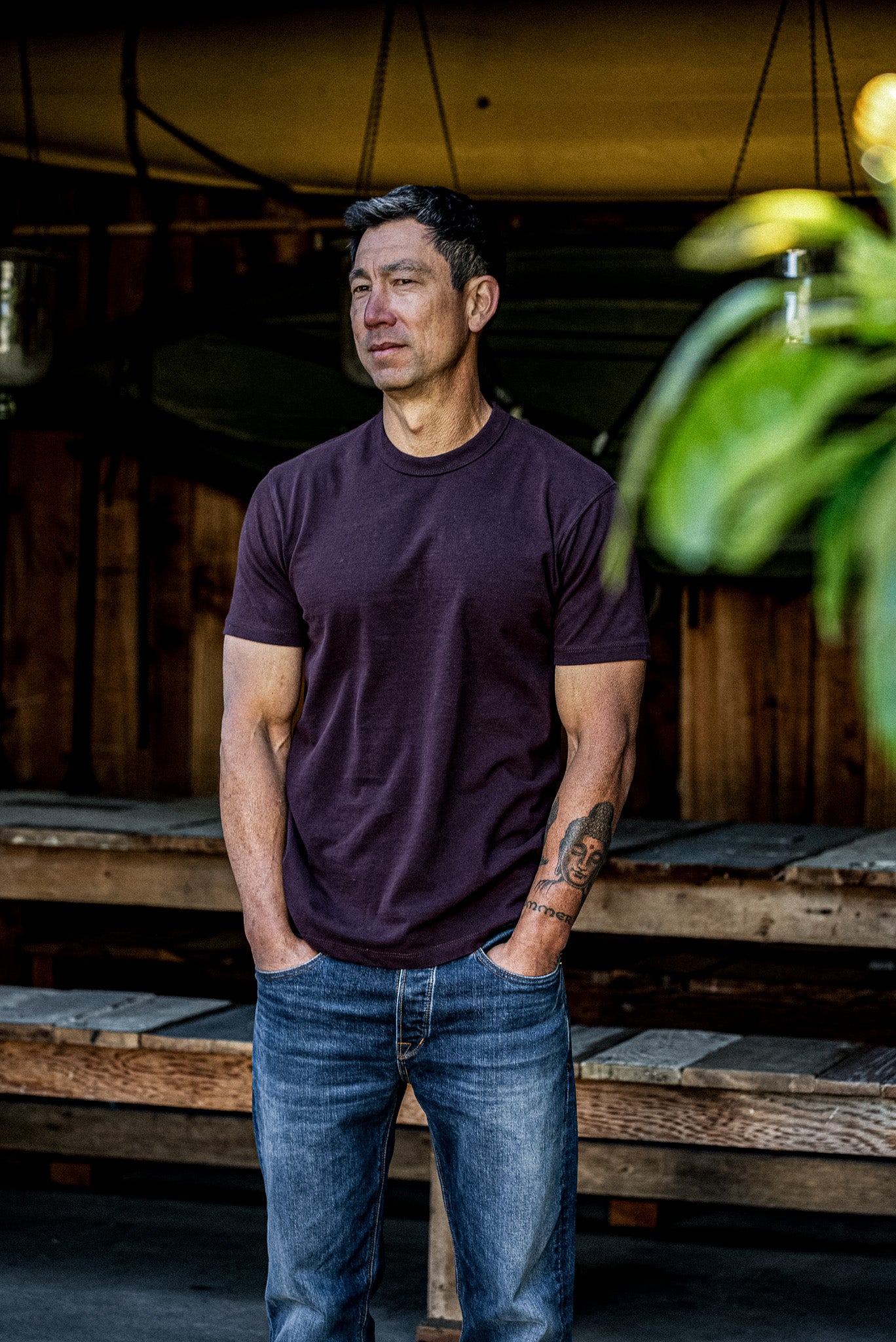 Oxblood heavyweight cotton Bolinas tee worn on-model with blue jeans, outdoor lifestyle shot.