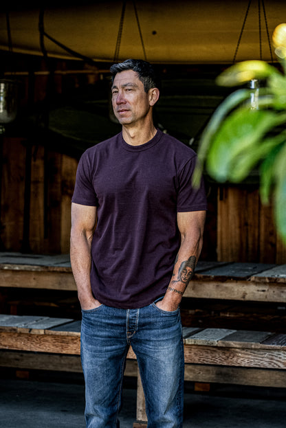 Oxblood heavyweight cotton Bolinas tee worn on-model with blue jeans, outdoor lifestyle shot.