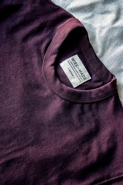 Close-up of oxblood heavyweight cotton tee collar with WiesMade neck label, size medium.
