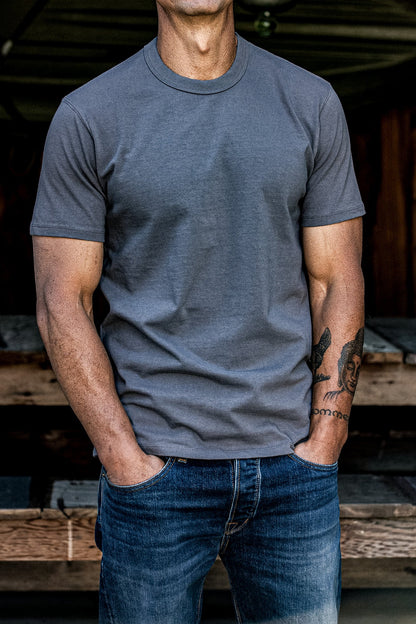 Pebble heavyweight cotton t-shirt on a man with dark blue jeans, hands in pockets.