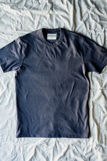 Men's pebble gray Bolinas t-shirt laid flat on textured surface