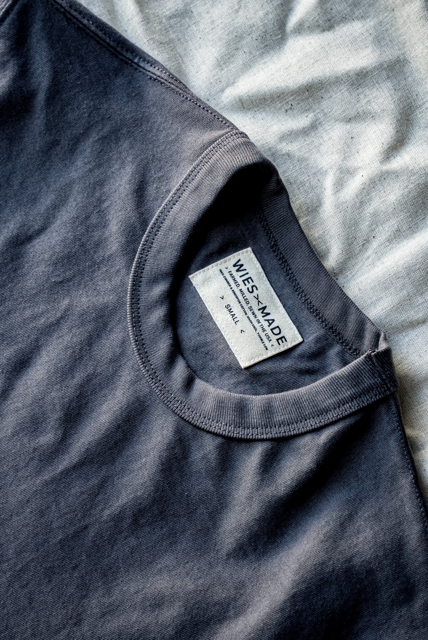 Close-up of Wies-Made men's pebble gray t-shirt neckline and label