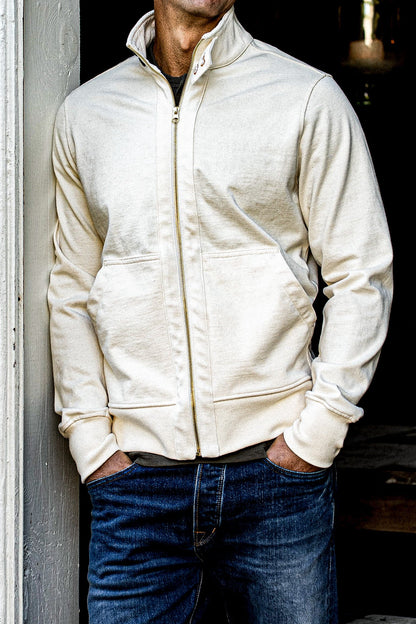 Man wearing the natural 12oz cotton Stinson moto zip jacket with brass zipper over jeans.
