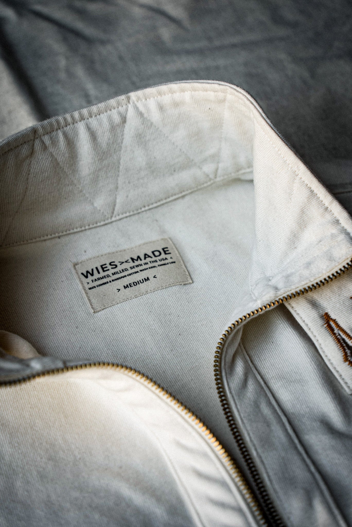 WiesMade label inside a natural cotton moto zip jacket, sewn in the USA, brass zipper.
