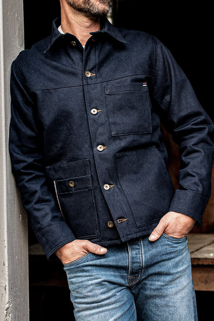 WiesMade Nico navy denim jacket buttoned up on a model showing chest pockets, brass buttons, and selvedge trim.