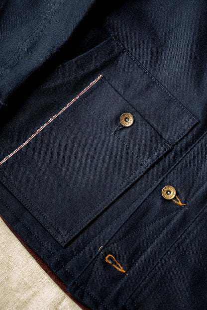 WiesMade Nico jacket in navy flat lay detail showing brass buttons, selvedge edge, and pocket construction.