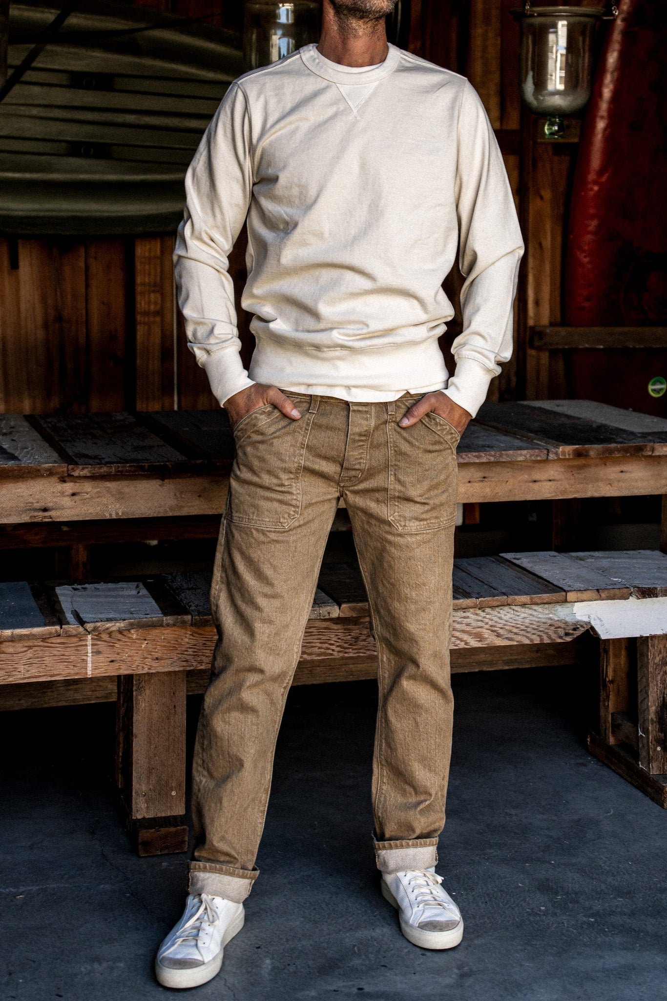Wheat Scout military denim pants worn on-model with cuffed hems and utility pockets.
