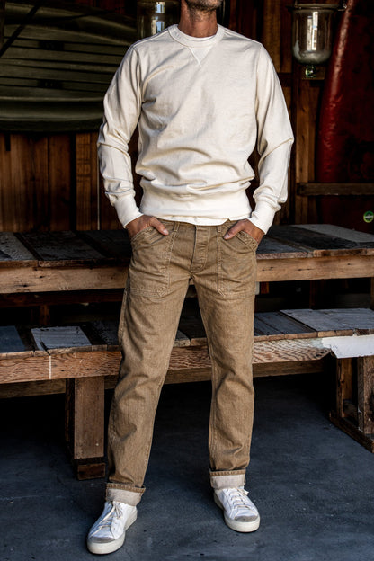 Wheat Scout military denim pants worn on-model with cuffed hems and utility pockets.