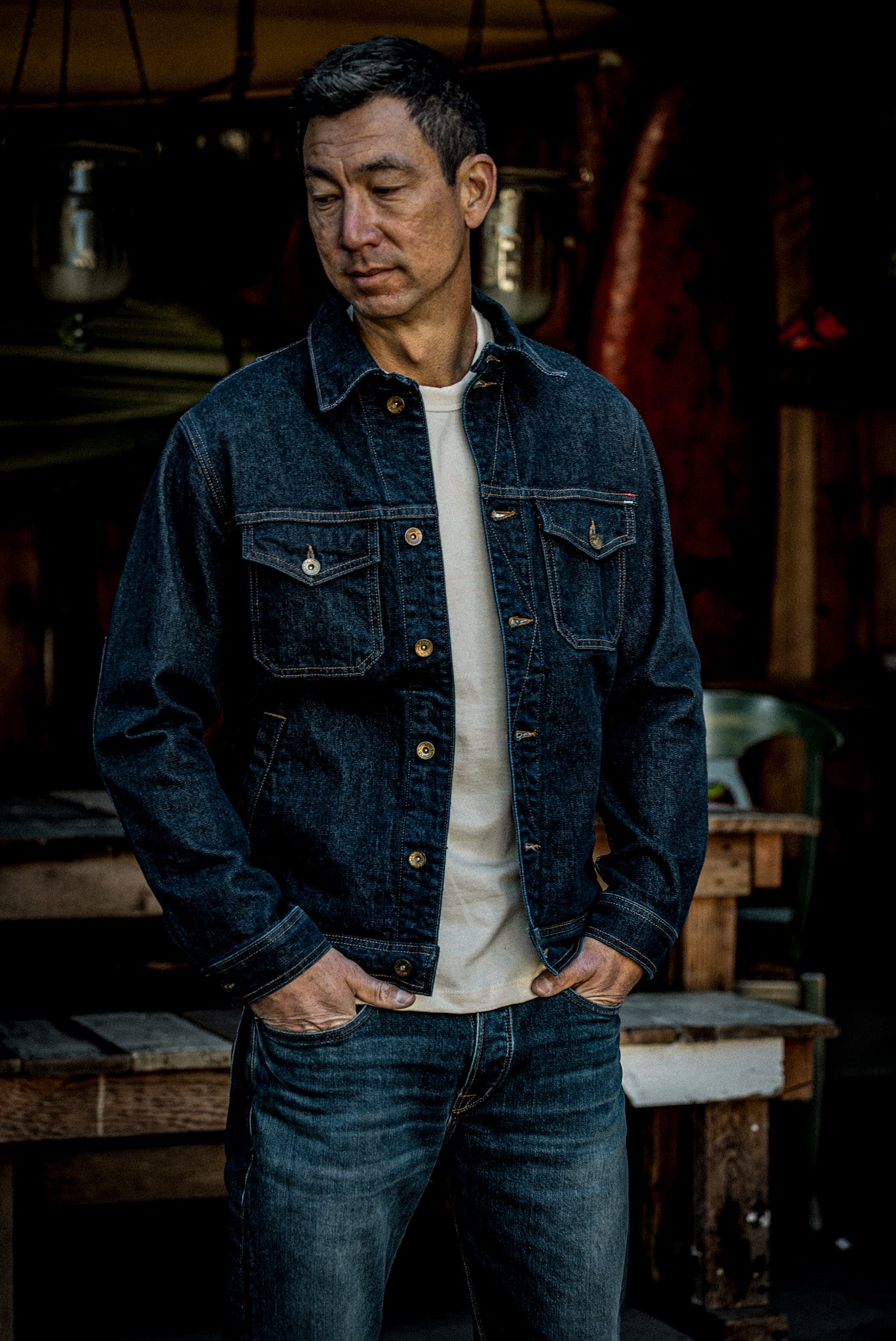 Man wearing the Artcher broken twill denim jacket in Ocean over a cream tee.
