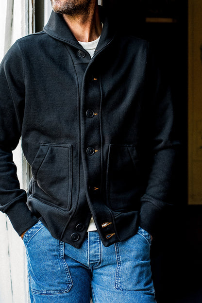 On-model Bodega shawl cardigan in basalt French terry with tobacco keyholes over jeans.