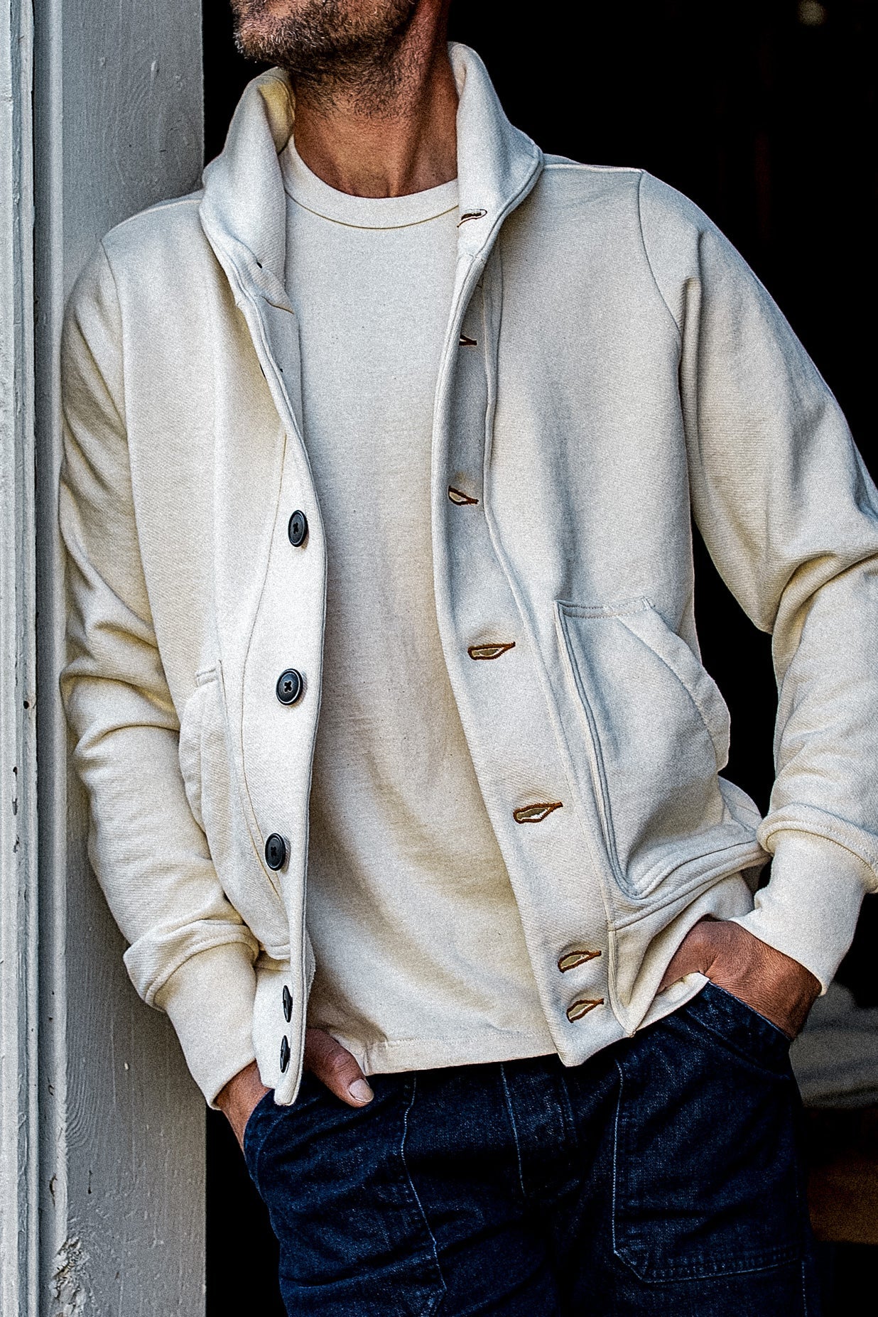 Natural French terry cardigan worn open over a matching tee with dark jeans.