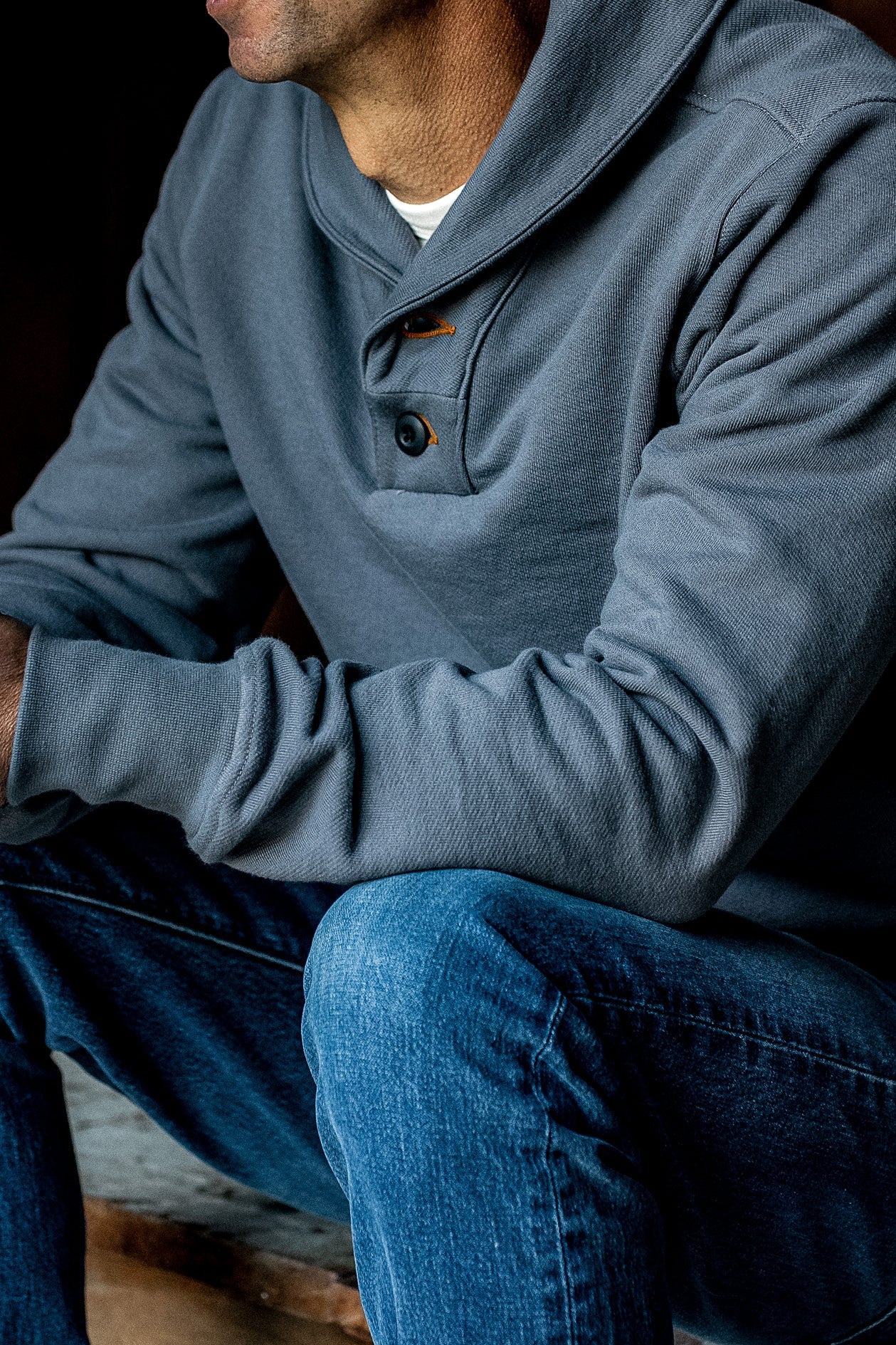 Pebble gray Bodega shawl collar pullover worn on-model with two-button placket over blue jeans.