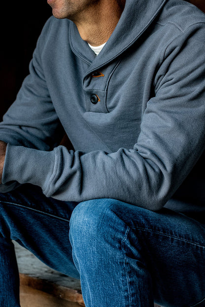 Pebble gray Bodega shawl collar pullover worn on-model with two-button placket over blue jeans.