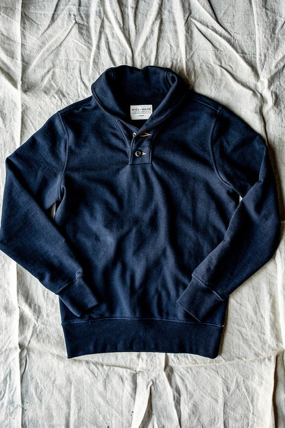 Navy shawl collar pullover in 14oz cotton French terry, flat-lay with button placket.