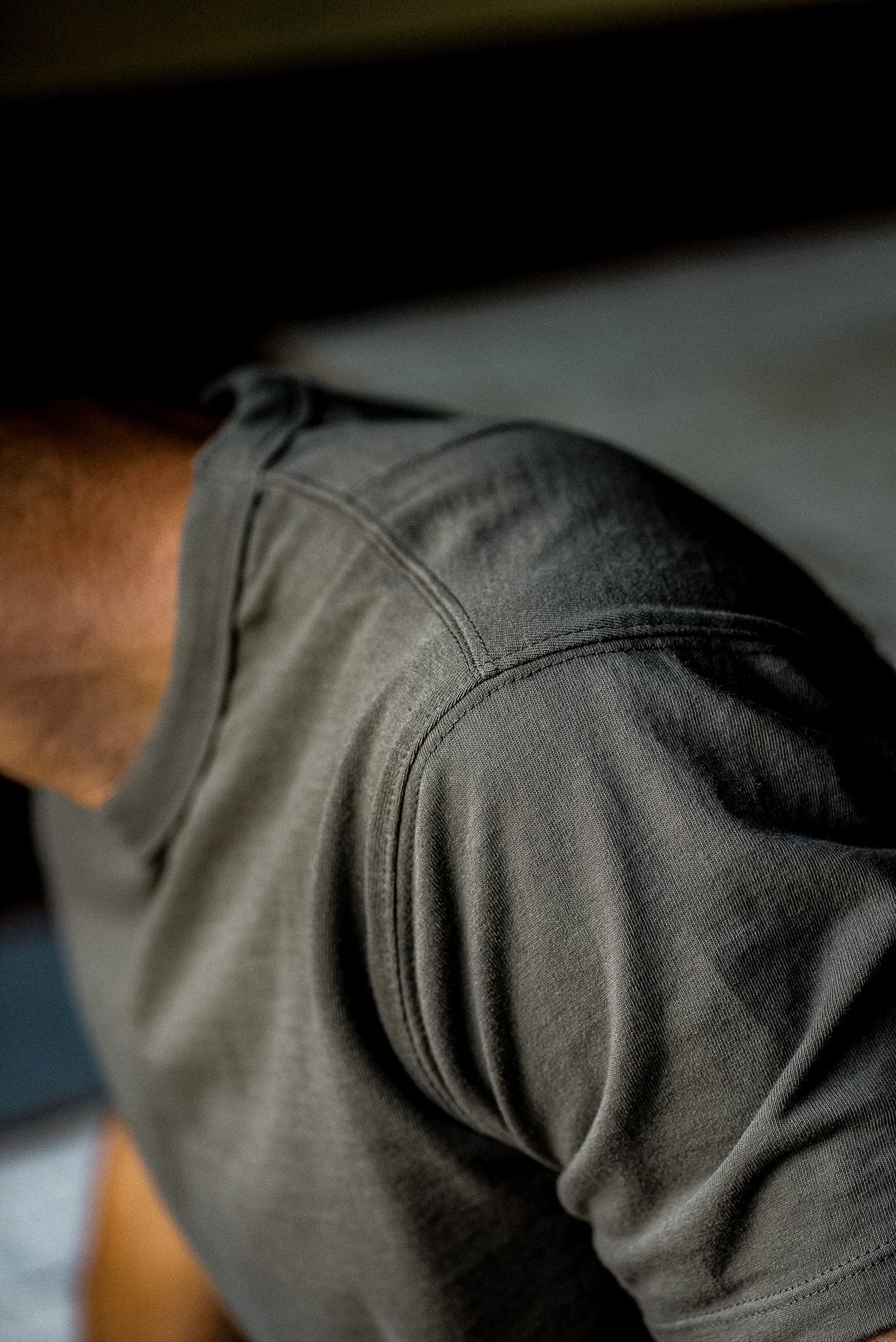 Close-up of the tailored shoulder seam on the olive heavyweight cotton Bolinas tee.