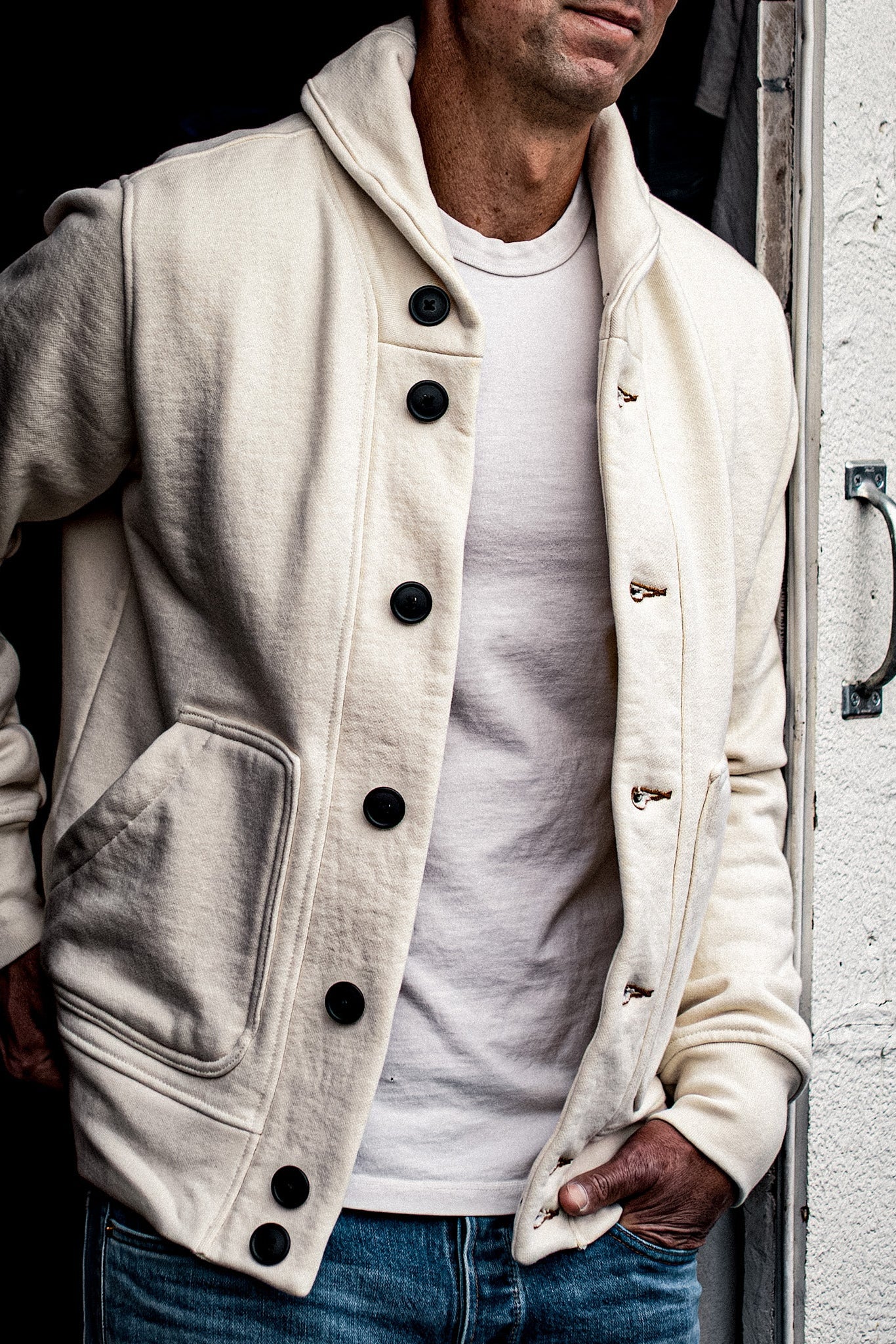 Natural cotton French terry Bodega cardigan worn open over a white tee, on-model detail.