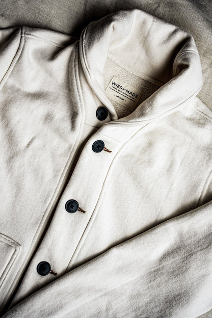 Natural cotton French terry shawl cardigan with dark buttons, tobacco keyhole stitching, and WiesMade label.