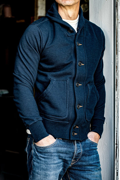 Navy shawl collar French terry cardigan worn over a cream tee with selvedge denim jeans.