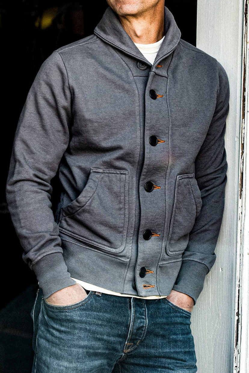 Pebble grey shawl collar cardigan in French terry, buttoned over a cream tee with denim jeans.