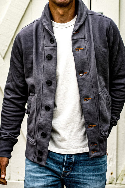 Pebble shawl collar French terry cardigan with black buttons and tobacco keyhole stitching, worn open over a white tee and.