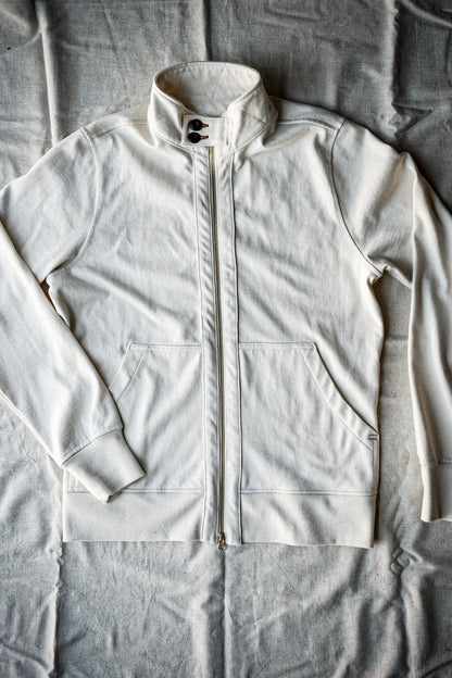 Natural cotton Stinson moto zip jacket laid flat, brass front zipper and stand collar.
