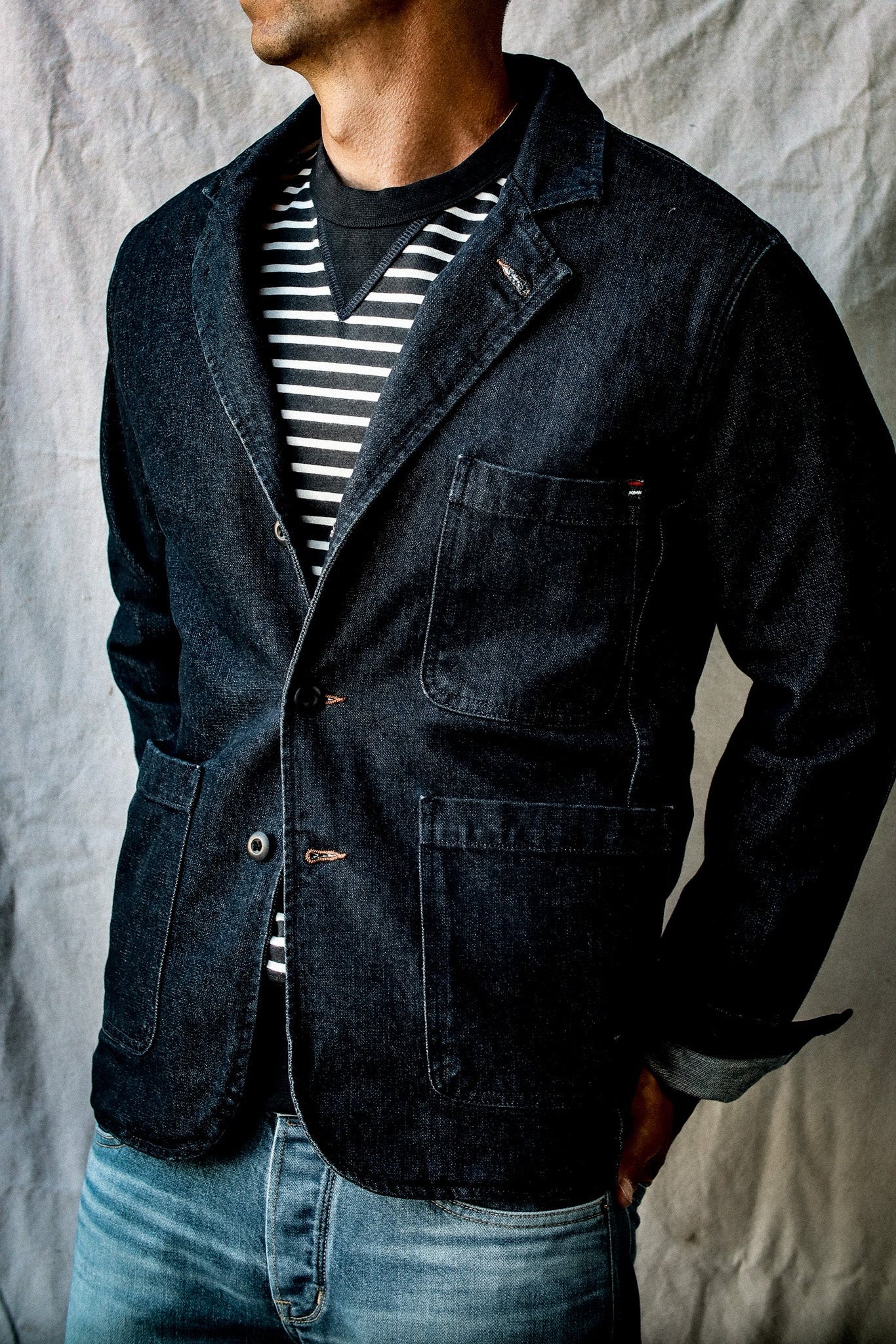 Model wears the Scout denim chore blazer over a striped tee with light jeans.