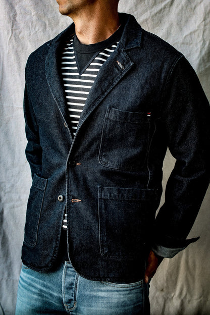 Model wears the Scout denim chore blazer over a striped tee with light jeans.