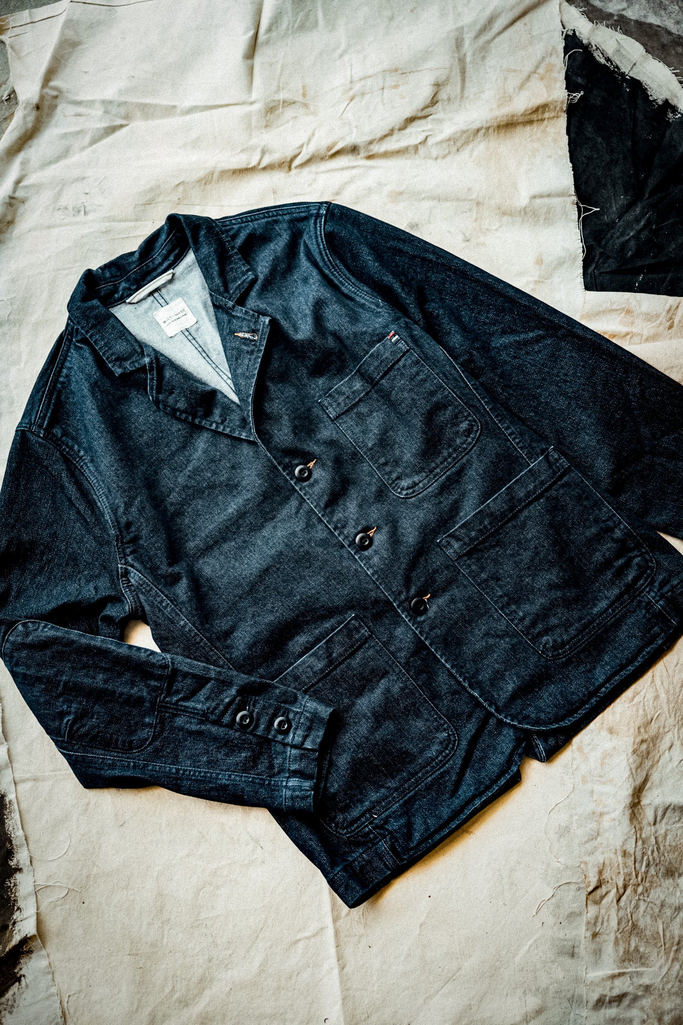 Men's Scout denim chore blazer in ocean indigo, flat-laid on canvas with patch pockets.
