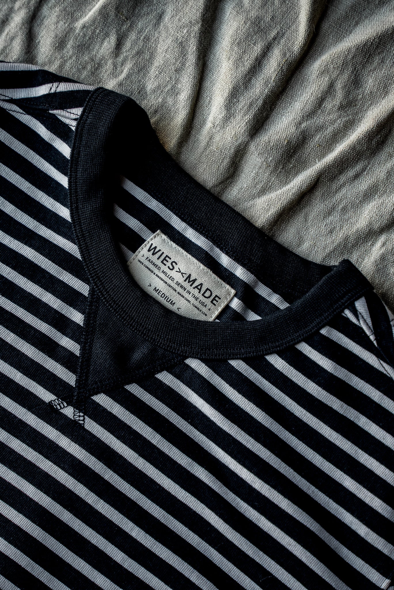 Close-up of the Stinson rugby jersey pullover neckline showing navy and white stripes with a WiesMade Made in USA label.