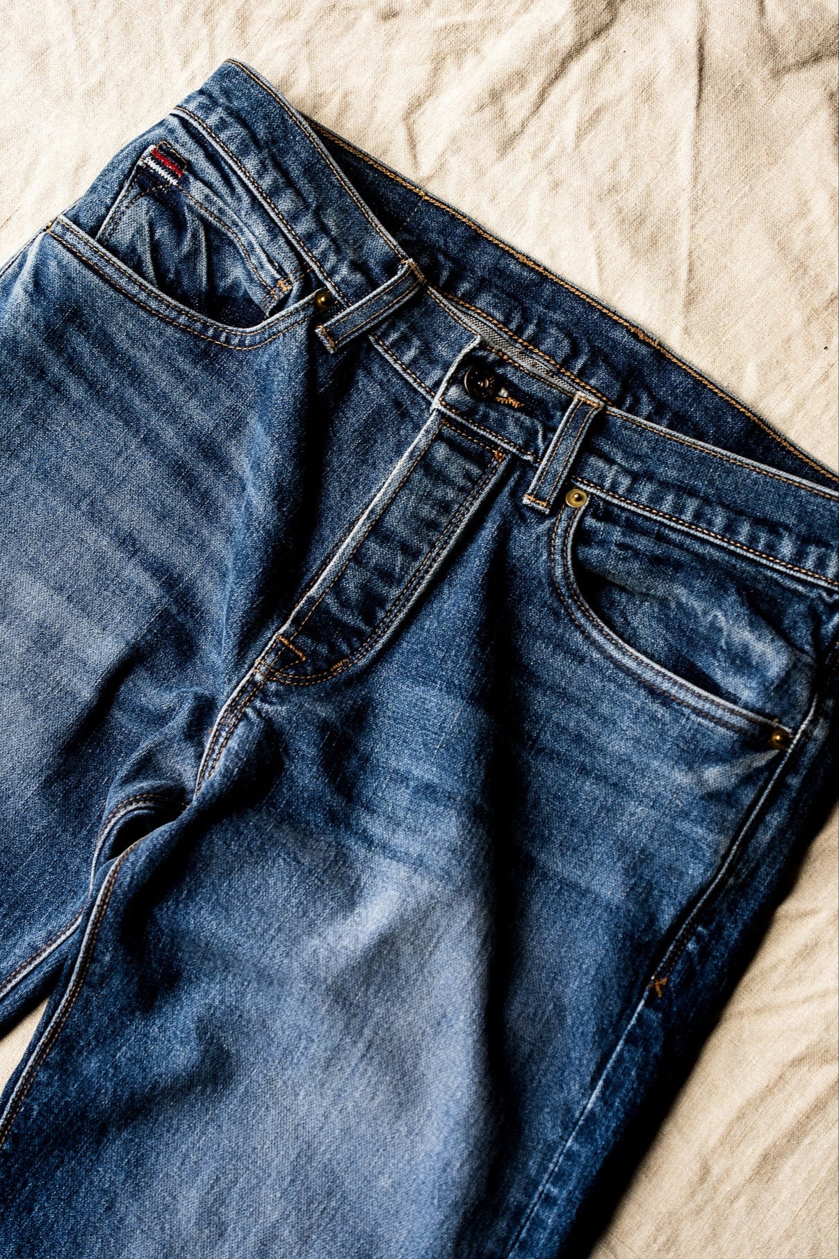 Men’s premium jeans crafted from soft, midweight denim, featuring a classic five-pocket design, medium blue wash, and tailored fit for versatile, everyday wear
