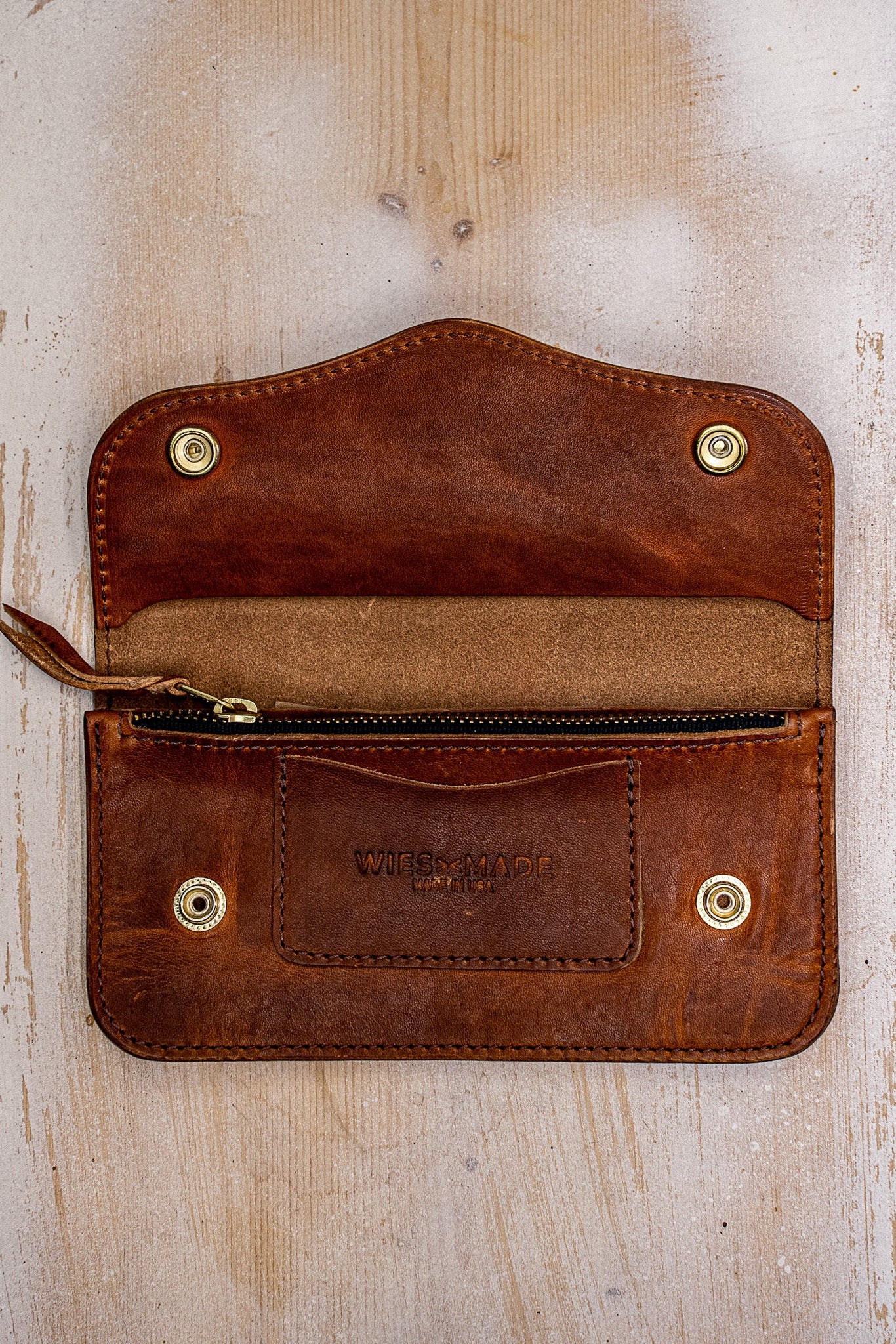 Open tan Horween leather Roper wallet showing brass snaps, zip pocket, and WiesMade stamp.