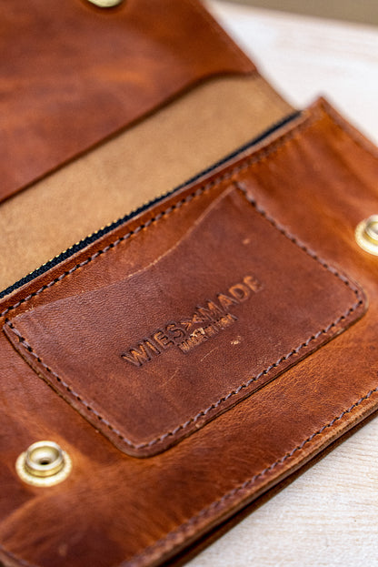 Open tan Horween leather Roper wallet interior with card pocket and embossed WiesMade stamp.