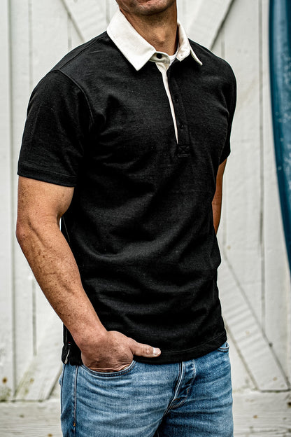 Men's black rugby polo shirt with white contrast collar, casual outdoor style