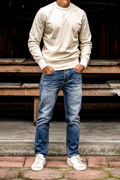 Designer blue jeans for men crafted from premium denim, featuring a straight leg silhouette, subtle whiskering, and a soft fade for a refined everyday appearance