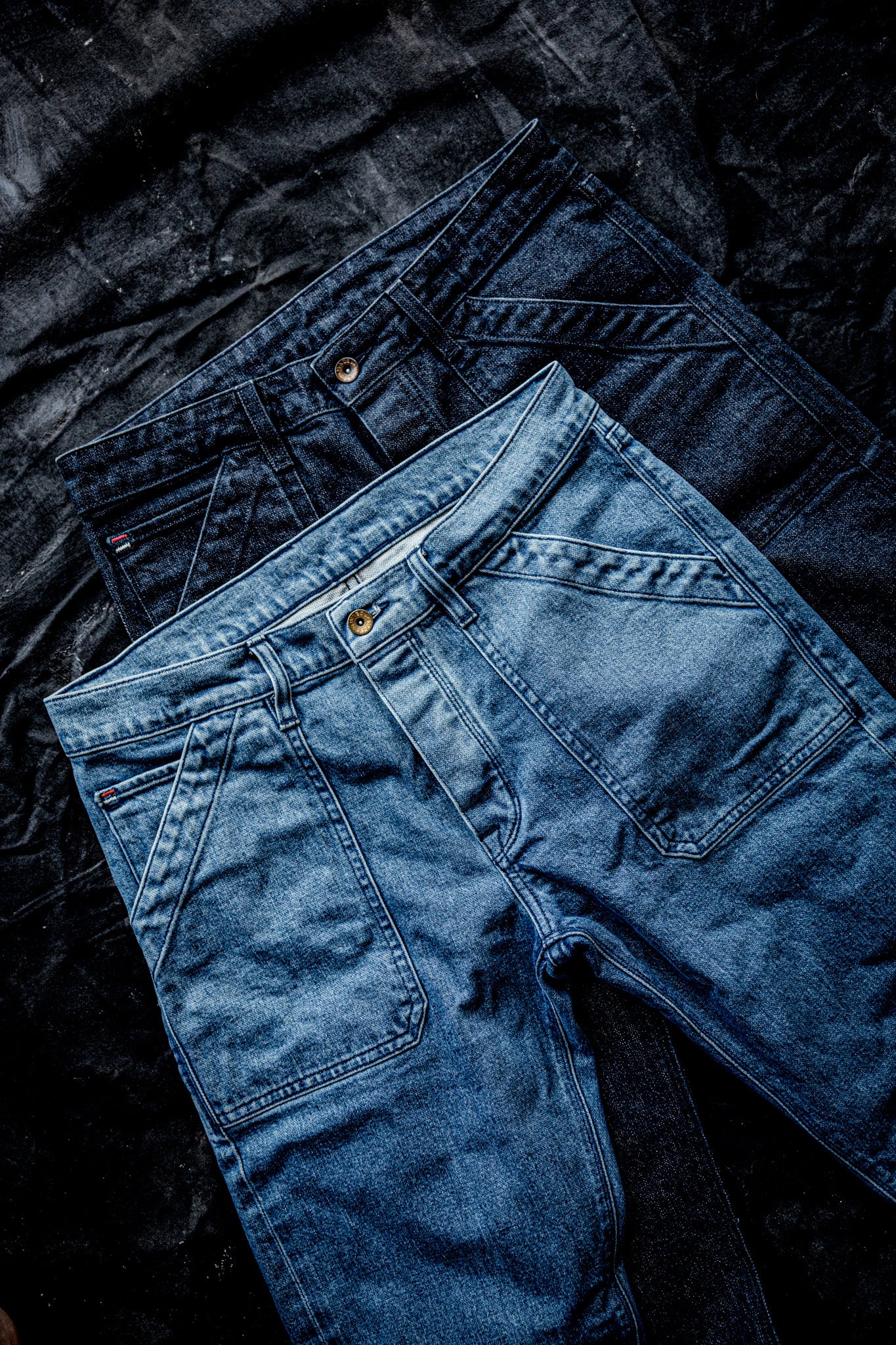 WiesMade Scout jeans flat lay in two colorways — dark indigo and light salt wash — showing front pocket and carpenter detail.