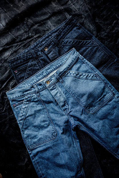 WiesMade Scout jeans flat lay in two colorways — dark indigo and light salt wash — showing front pocket and carpenter detail.