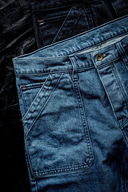 WiesMade Scout jeans in salt wash flat lay detail showing front yoke seam, carpenter pocket, and brass button fly.