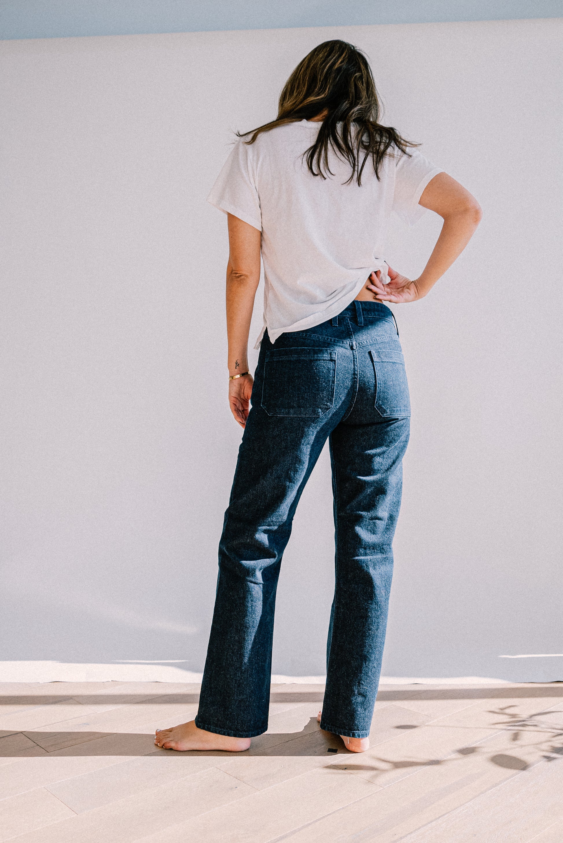 American ocean wash denim jeans shown from the back, featuring a straight leg fit, structured seams, and deep indigo tone for a clean, modern silhouette