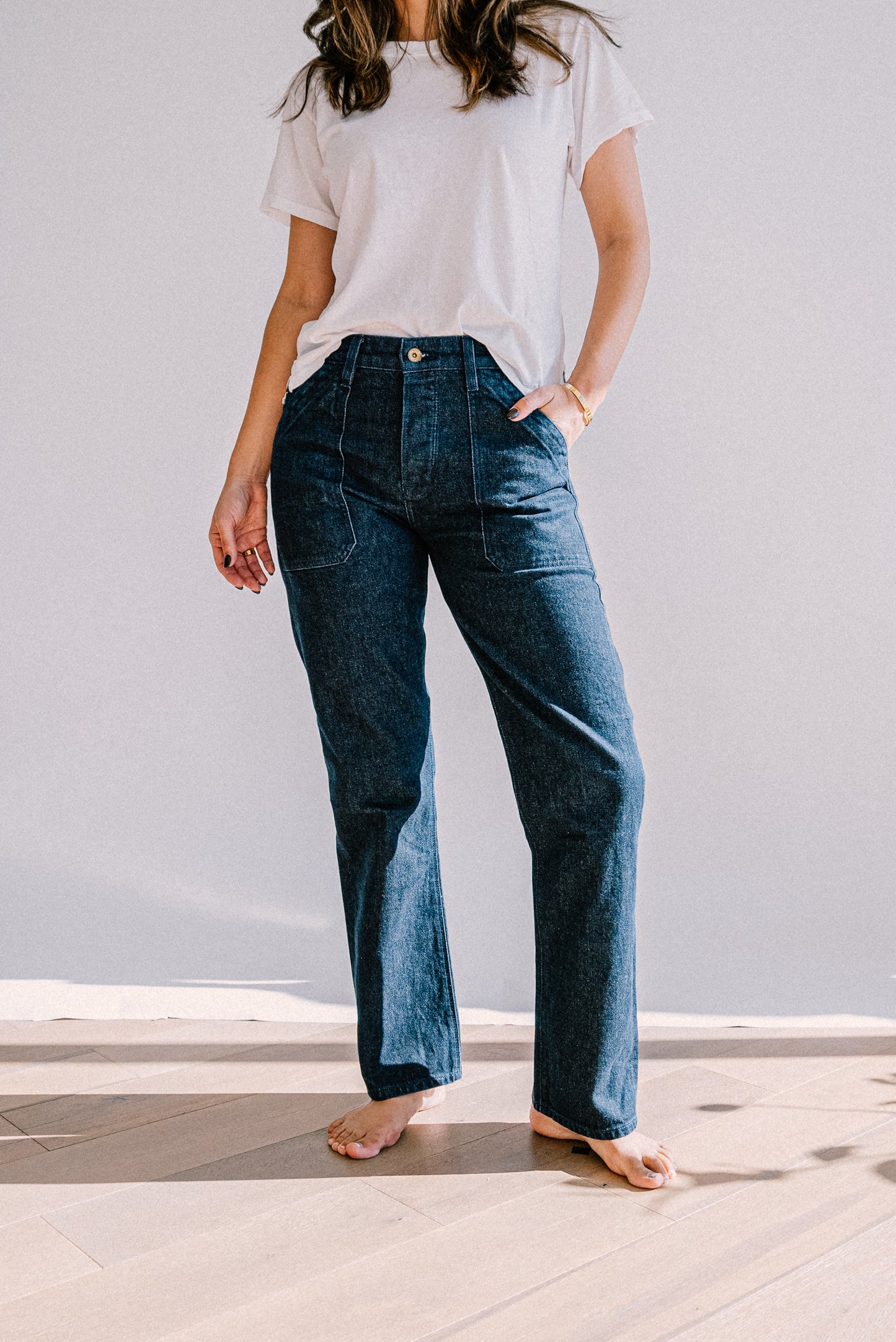 Premium ocean wash denim jeans featuring a straight leg cut, high rise fit, and front utility pockets, styled with a simple white tee for a clean, effortless look
