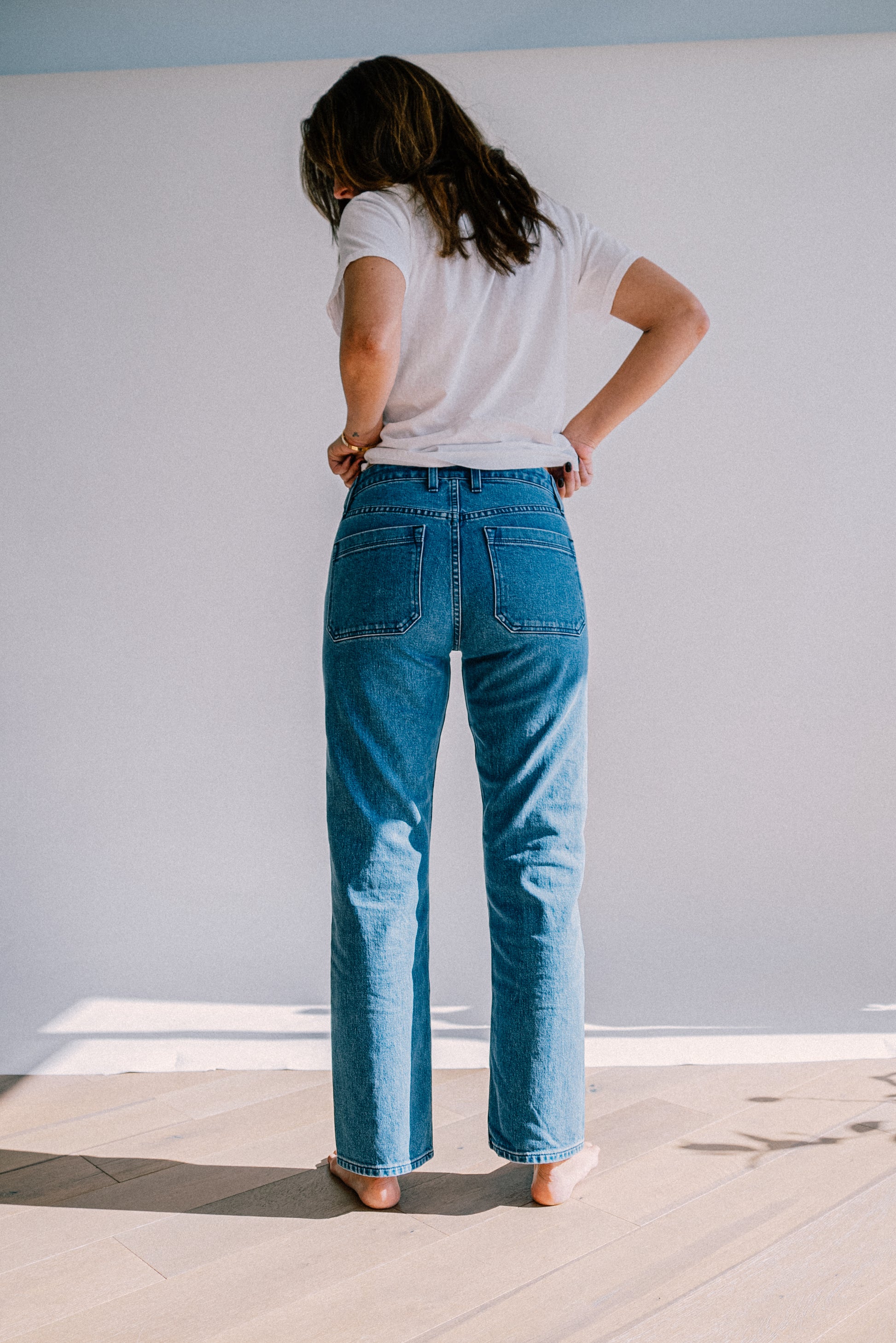 Premium salt wash jeans for women shown from the back, featuring a light blue wash, high rise fit, and straight leg design for a clean, relaxed look