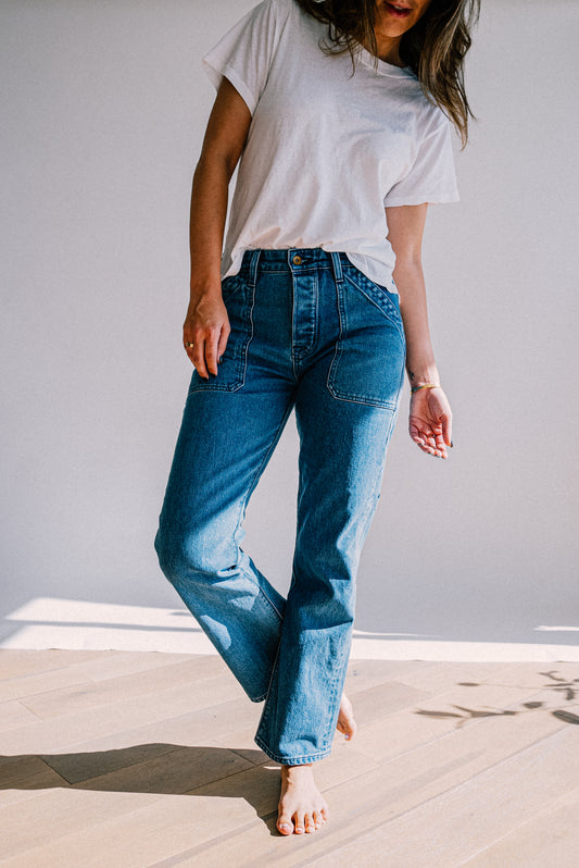 Women’s premium salt wash jeans with a light blue tone, high rise fit, and front utility pockets, styled with a casual white tee for an effortless everyday look